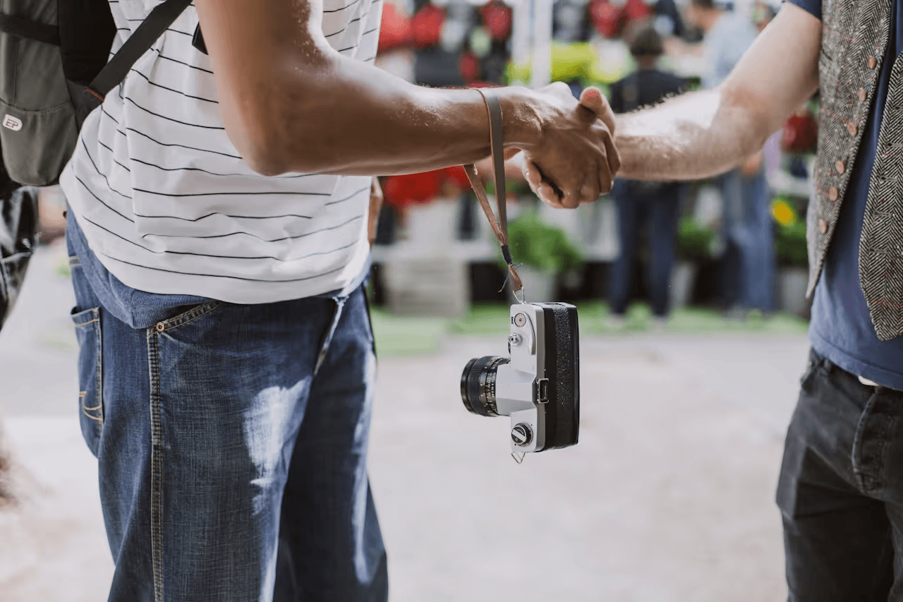shaking hands with a camera.png